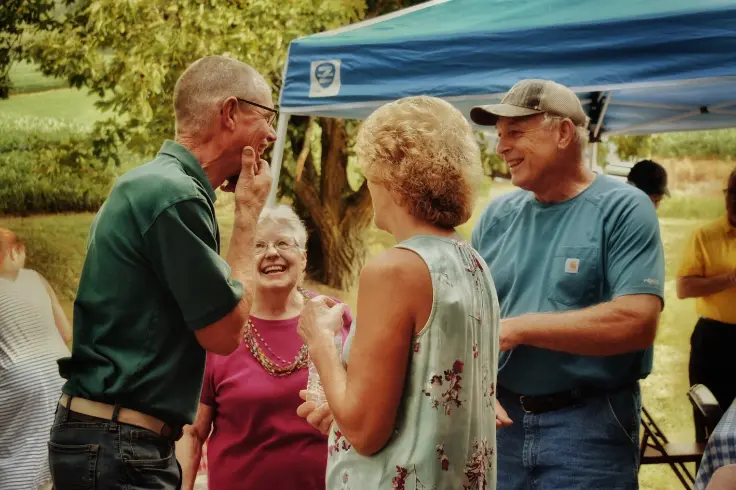 four older people laughing